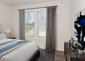 Thumbnail 9 of 60 - a bedroom with a large window and a bed with a blue and white striped comforter