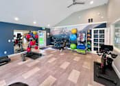 Thumbnail 17 of 30 - A gym with a variety of exercise equipment including treadmills, stationary bikes, and weights