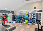 Thumbnail 16 of 30 - A gym with a variety of equipment including a treadmill, exercise balls, and weights.