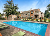 Thumbnail 21 of 30 - A large swimming pool surrounded by lounge chairs