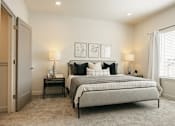Thumbnail 20 of 20 - A bedroom with a large bed and two nightstands.
