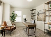 Thumbnail 17 of 20 - A room with a brown leather chair and a wooden table.