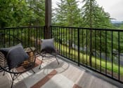 Thumbnail 5 of 38 - Balcony with two chairs and a view of trees and a river at Arbor Heights, Tigard, 97224