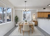 Thumbnail 6 of 36 - A dining room with a table set for six.