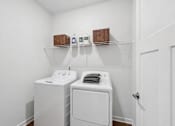 Thumbnail 27 of 28 - A white laundry room with a washer and dryer.