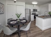 Thumbnail 7 of 23 - A modern kitchen with a dining table set for two.