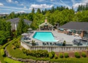 Thumbnail 30 of 38 - an aerial view of a resort style swimming pool with patio furniture and umbrellasat Arbor Heights, Tigard, Oregon