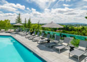 Thumbnail 26 of 38 - a pool with lounge chairs and umbrellas at Arbor Heights, Oregon