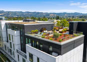 Thumbnail 53 of 54 - a building with a green roof with plants on top of it
