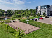 Thumbnail 28 of 35 - A park area with a fence and a playground.