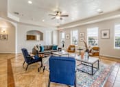 Thumbnail 31 of 34 - a living room with furniture and a ceiling fan