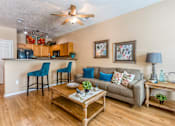 Thumbnail 20 of 34 - a living room and kitchen with a couch and a coffee table