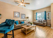 Thumbnail 21 of 34 - a living room with furniture and a ceiling fan