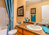 Thumbnail 24 of 34 - a bathroom with a sink and a toilet and a shower