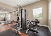 Thumbnail 5 of 34 - a home gym with exercise equipment and windows