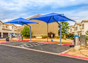 Thumbnail 7 of 34 - an empty parking lot with blue umbrellas in a parking lot
