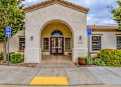 Thumbnail 34 of 34 - the front door of a building with two blue signs on either side of the door
