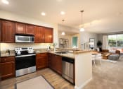 Thumbnail 16 of 30 - a kitchen and living room with a counter top