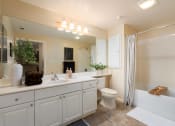 Thumbnail 24 of 30 - a bathroom with a large mirror and a sink and a toilet