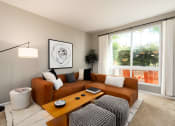 Thumbnail 19 of 30 - a living room with a brown couch and a coffee table