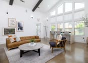 Thumbnail 5 of 35 - a living room with white walls and ceilings and a large window