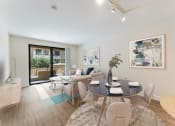 Thumbnail 1 of 21 - a living room with a round dining table and a sliding glass door