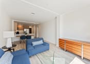 Thumbnail 8 of 54 - a living room with blue couches and a glass table