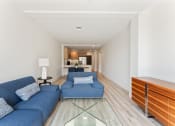 Thumbnail 4 of 54 - a living room with blue couches and a glass table