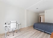 Thumbnail 14 of 54 - a bedroom with a bed and a desk with a chair