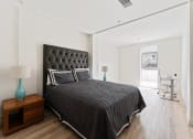 Thumbnail 13 of 54 - a bedroom with a large bed and a desk