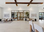 Thumbnail 20 of 57 - A spacious room with a white floor and a ceiling with wooden beams.