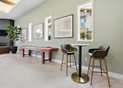 Thumbnail 43 of 57 - A room with a table and chairs and pictures on the wall.
