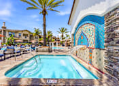 Thumbnail 3 of 57 - A pool with a blue tiled wall and a palm tree in the background.