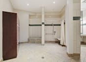 Thumbnail 48 of 57 - A bathroom with a walk-in shower and a wooden door.