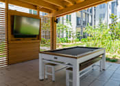 Thumbnail 55 of 59 - A table tennis table is set up on a patio.