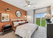 Thumbnail 8 of 50 - a bedroom with a bed and a ceiling fan