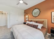 Thumbnail 7 of 50 - a bedroom with a bed and a ceiling fan