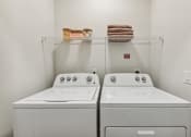 Thumbnail 12 of 50 - two washers and a dryer in a laundry room