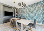 Thumbnail 30 of 50 - a dining room with a wooden table and chairs and a large wall mural of trees