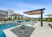 Thumbnail 42 of 50 - our apartments have a resort style pool with lounge chairs and umbrellas