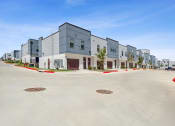 Thumbnail 49 of 50 - a street view of a row of new apartment buildings
