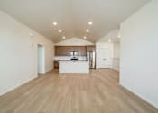 Thumbnail 10 of 23 - A kitchen with wooden floors and white walls at Bloom Rental Living apartments in Fort Collins, CO.