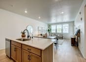 Thumbnail 8 of 23 - A kitchen with wooden cabinets and a white countertop at Bloom Rental Living apartments in Fort Collins, CO.