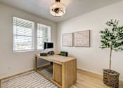 Thumbnail 7 of 23 - A room with a desk and a plant in the model office at Bloom Rental Living apartments in Fort Collins, CO