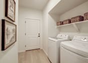Thumbnail 4 of 23 - Model laundry room with a washer and dryer. in Fort Collins, CO at Bloom Rental Living apartments in Fort Collins, CO.