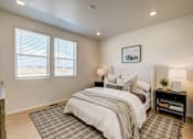 Thumbnail 3 of 23 - Model bedroom at Bloom Rental Living apartments in Fort Collins, CO, featuring a window with blinds.