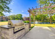 Thumbnail 15 of 32 - an outdoor kitchen with a grill and a pergola