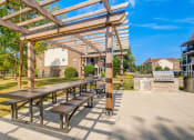 Thumbnail 13 of 32 - a picnic area with benches and a pergola