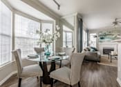 Thumbnail 6 of 14 - Dining room with glass table at The Retreat at Fox Hollow apartments for rent in Lakewood, CO.