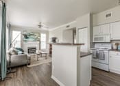 Thumbnail 5 of 14 - Modern kitchen with wooden island at The Retreat at Fox Hollow Lakewood, CO apartment.